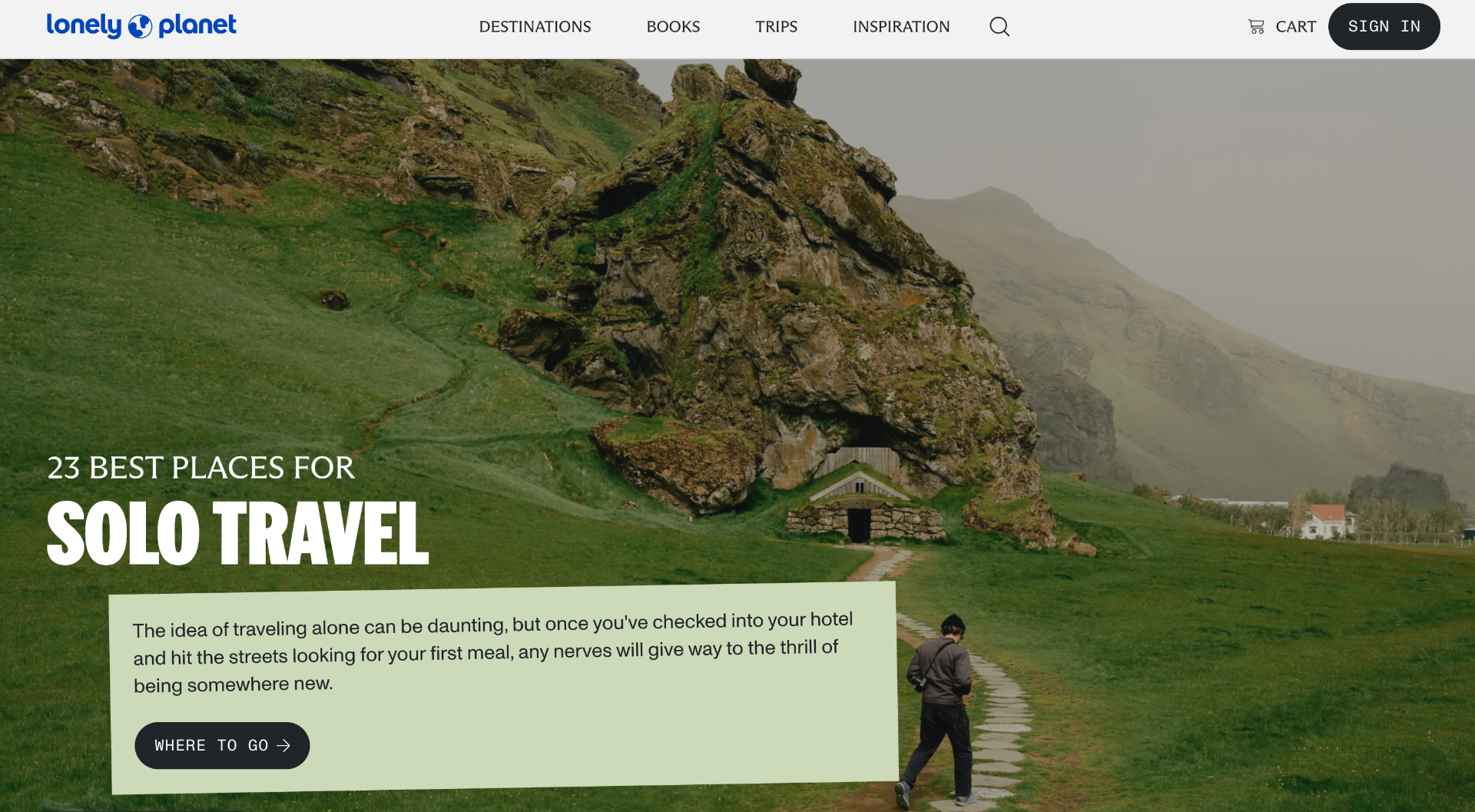 Lonely Planet solo travel hero — traveler walking a stone path through Icelandic mountains